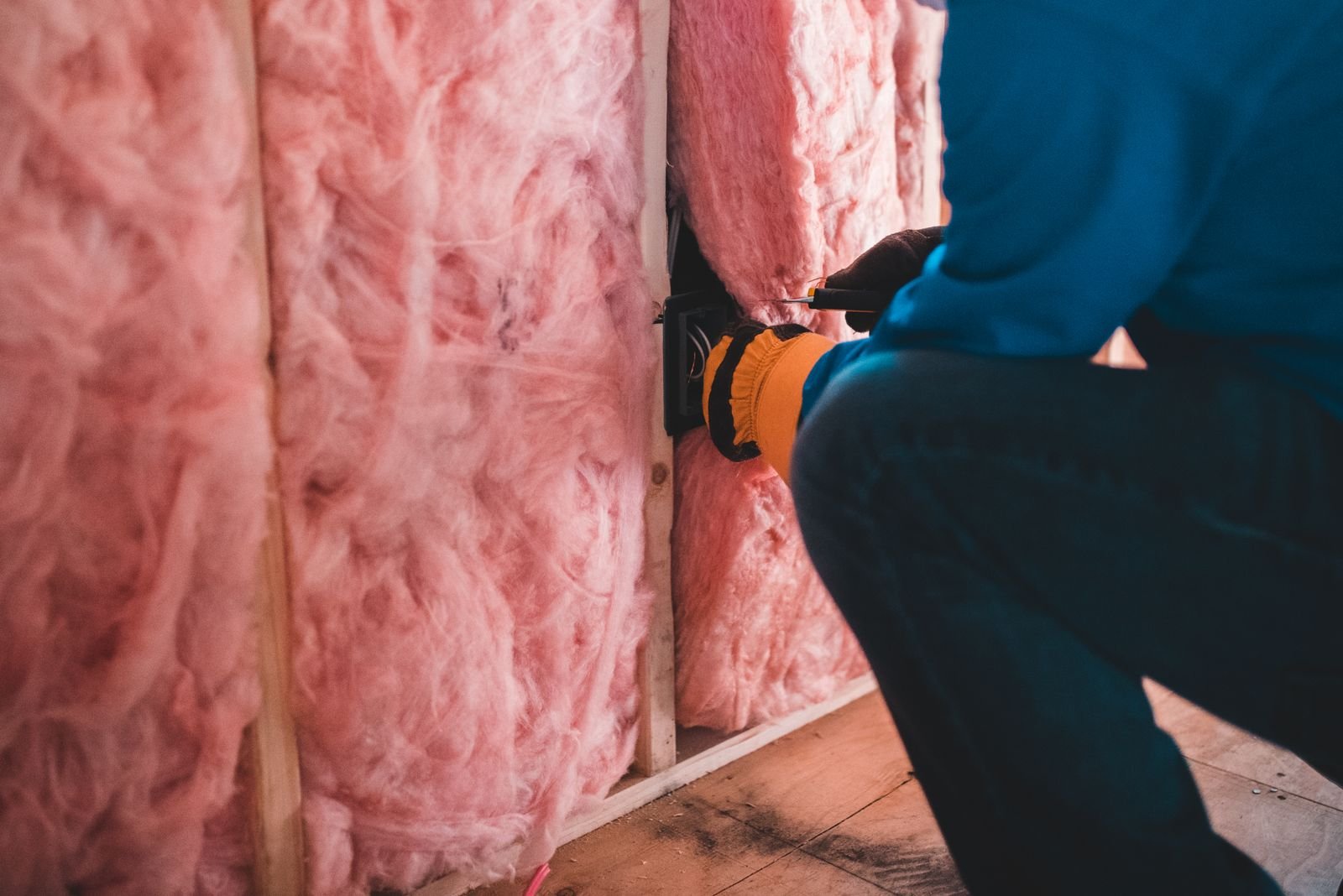 Technician inspecting crawlspace and foundation area for termite soil treatment in Denver, CO